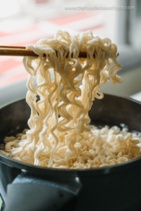 Instant ramen noodles cooked in a pot