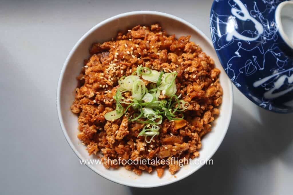 Shredded tofu bulgogi over steamed short grain rice in a ceramic bowl