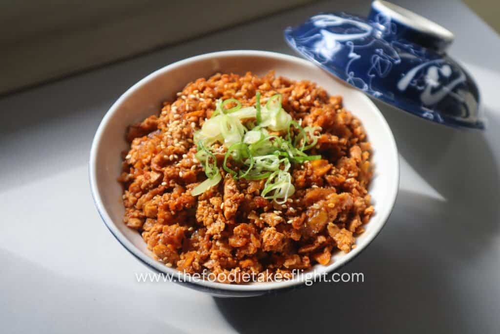 Shredded tofu bulgogi over steamed short grain rice in a ceramic bowl