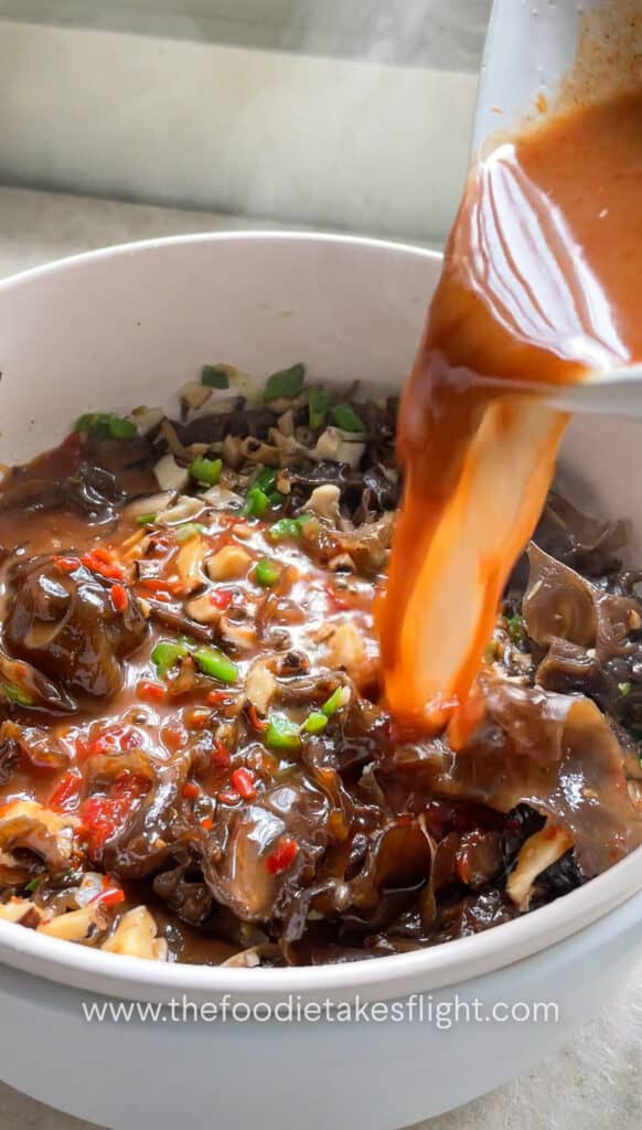 pouring the sauce into the pot