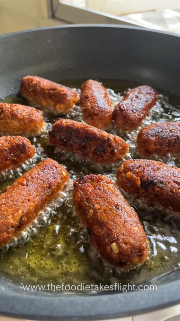 cooking longganisa or filipino sausages