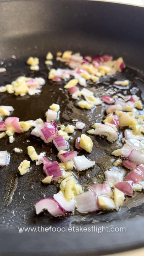 sautéing red onions and minced garlic in oil