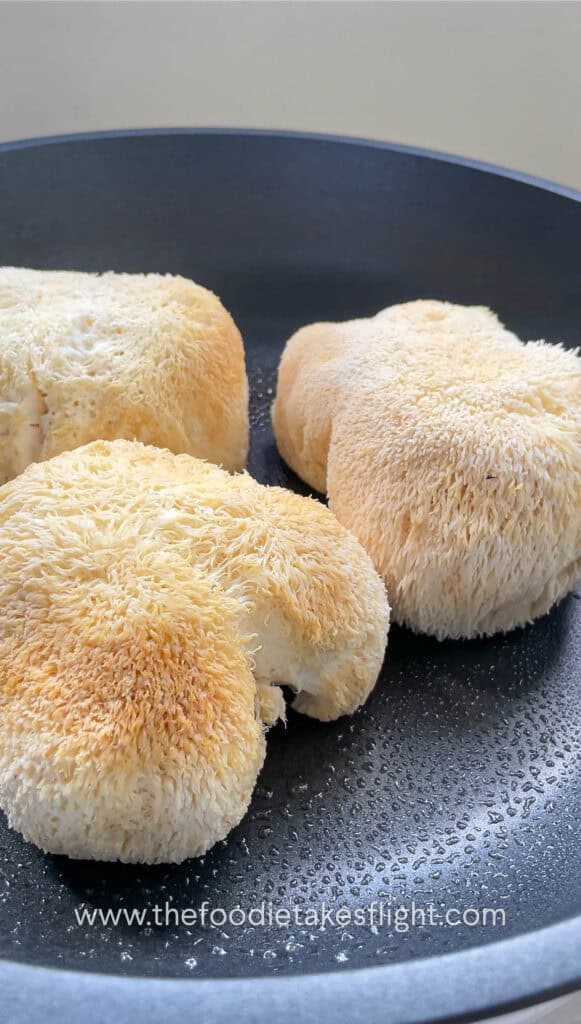 fresh lions mane mushrooms on the pan