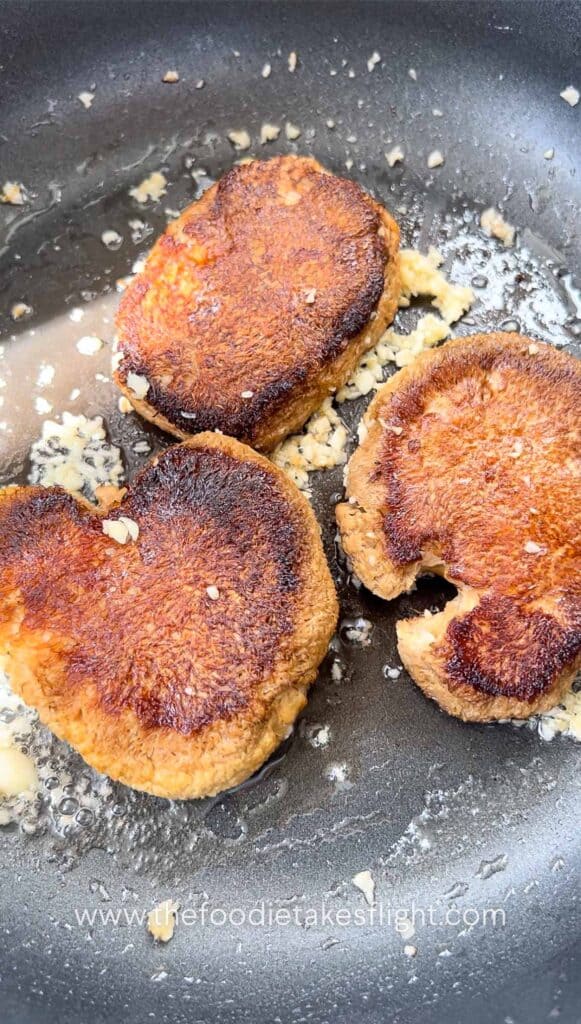 cooking the lions mane mushrooms with vegan butter and garlic