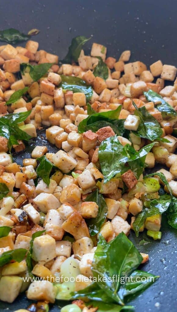 stir frying extra firm tofu and curry leaves