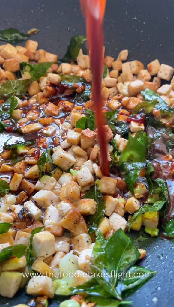 cooking sweet chili tofu with curry leaves