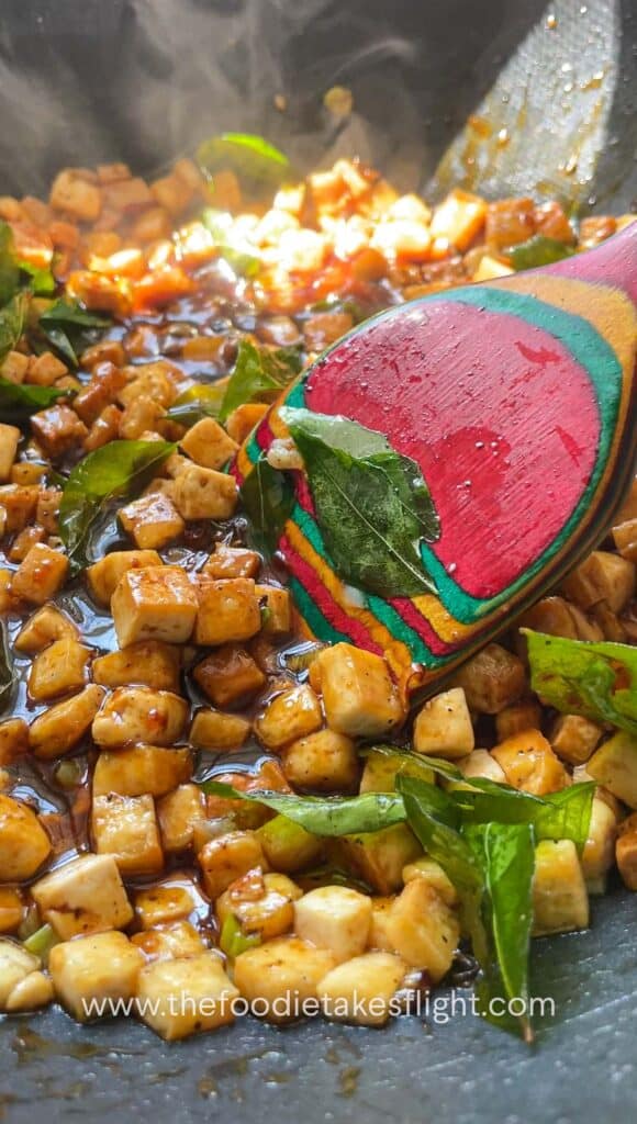 cooking sweet chili tofu with curry leaves