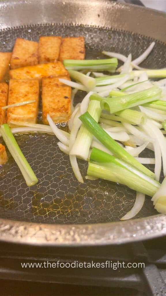 stir-frying onions with tofu