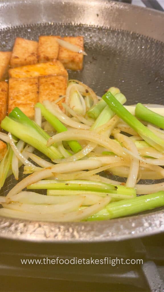 stir-frying onions with tofu