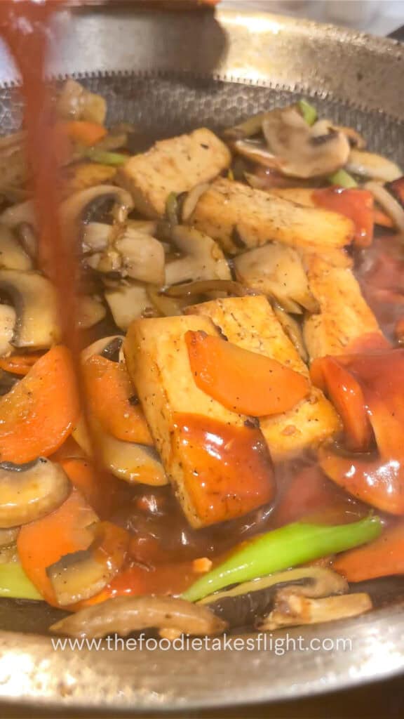 pouring the stir-fry sauce