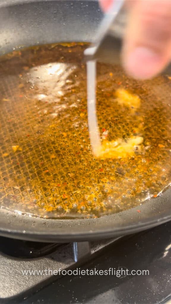 preparing the sauce for cabbage rolls in a pan