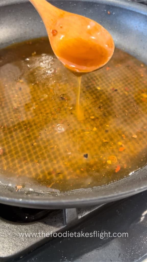 preparing the sauce for cabbage rolls in a pan