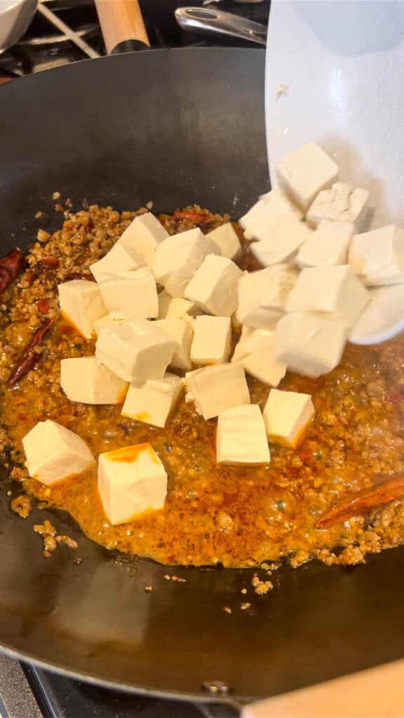 adding soft tofu to sauce