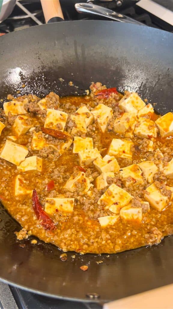 adding soft tofu to sauce