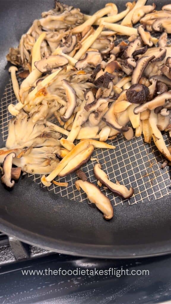 ginger mushrooms searing on a pan