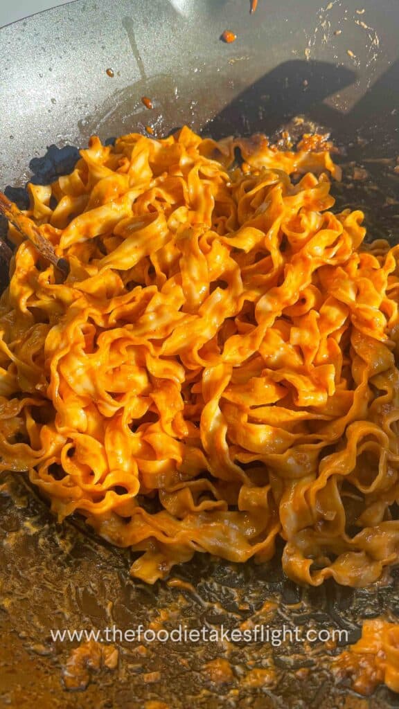 sweet chili tahini noodles in a wok