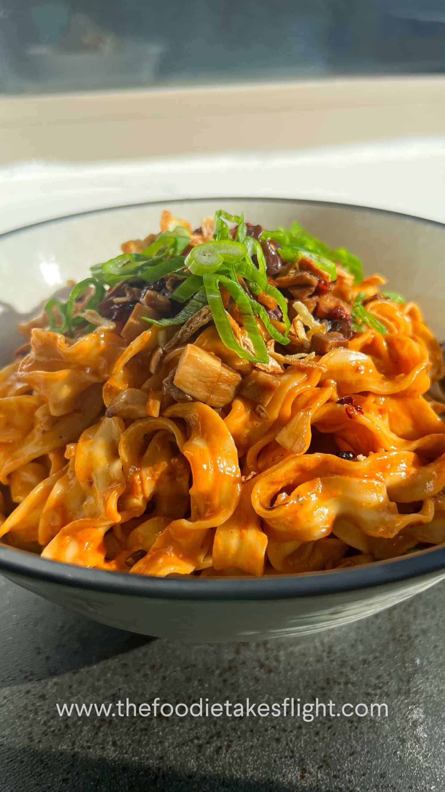 sweet chili tahini noodles in a wok
