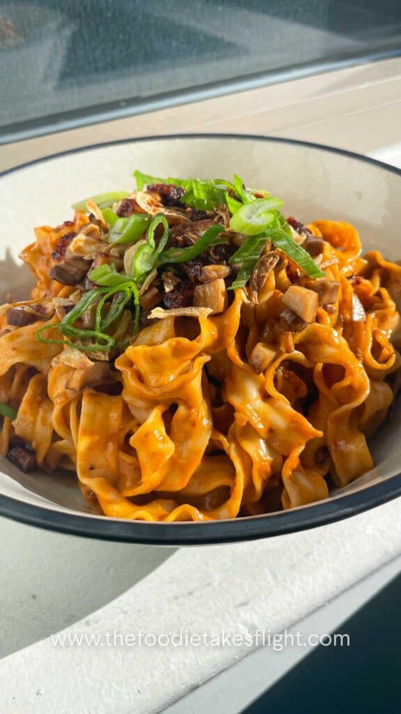 sweet chili tahini noodles in a wok