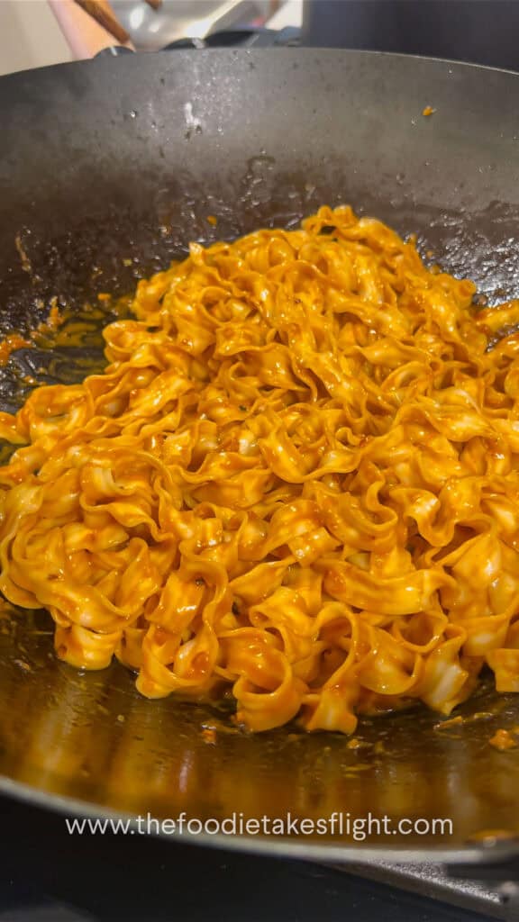 sweet chili tahini noodles in a wok