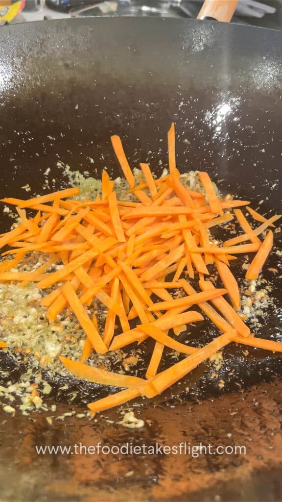 stir frying carrot in aromatics