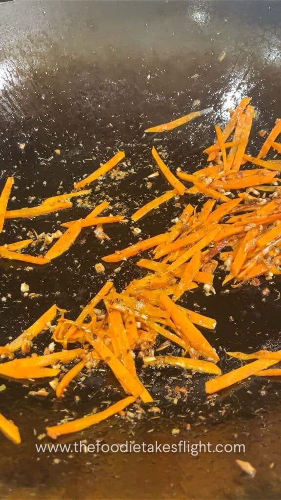 stir frying carrot in aromatics