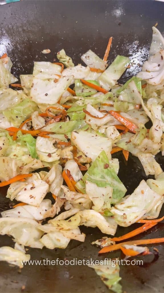 stir frying cabbage and carrot in aromatics