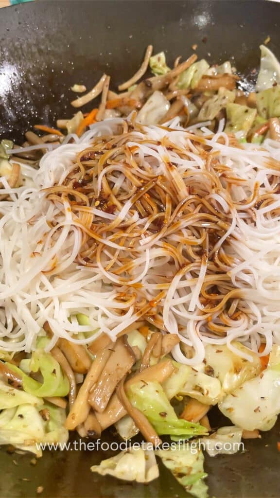 stir frying rice noodles with vegetables