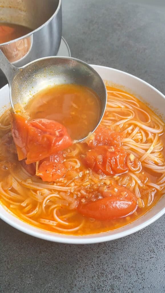 pouring soup over tomatoes