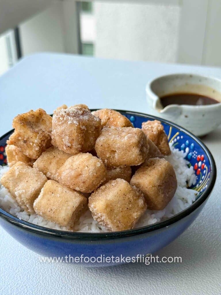Crispy golden tofu cubes in a bowl with rice