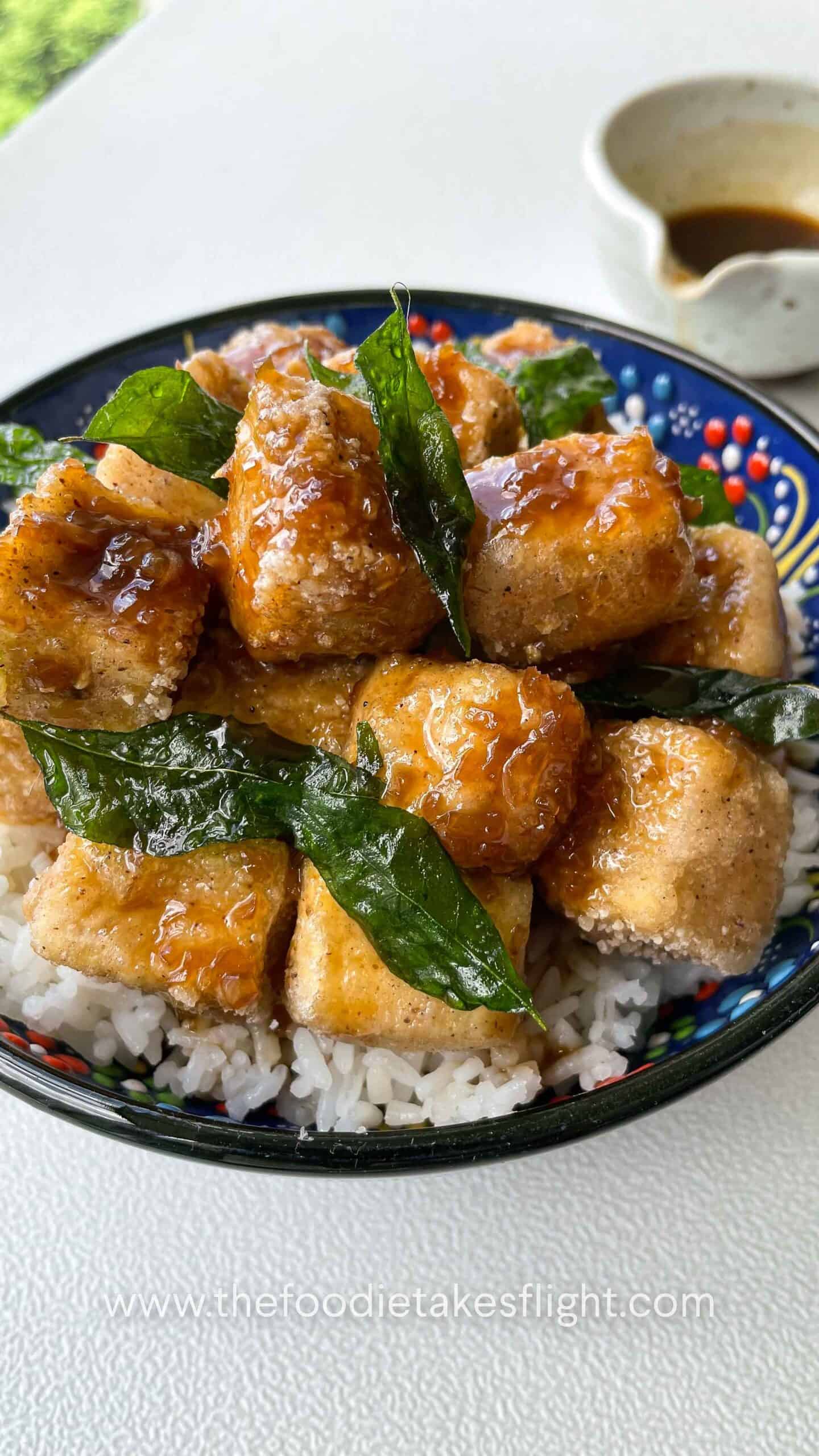 Crispy golden tofu cubes coated in a glossy soy citrus glaze, served with rice and garnished with fried curry leaves.
