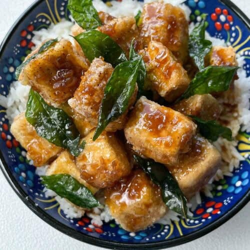 Crispy golden tofu cubes coated in a glossy soy citrus glaze, served with rice and garnished with fried curry leaves