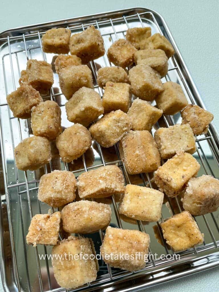 Crispy golden tofu cubes on a metal tray