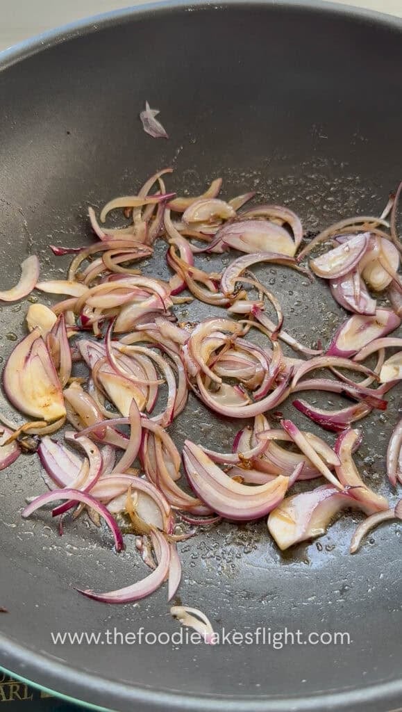 sautéing thinly sliced red onions in butter
