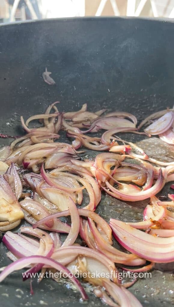 sautéing thinly sliced red onions in butter