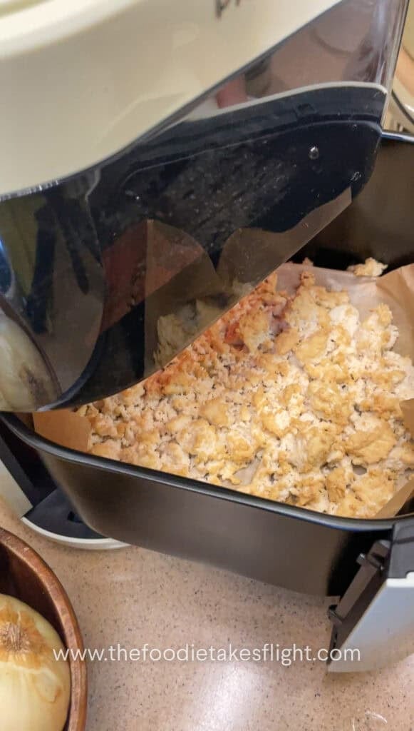 crumbled extra firm tofu in an air fryer basket