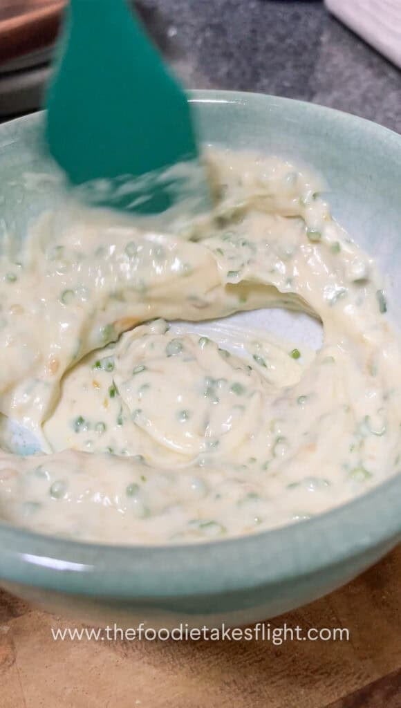 mayo, roasted garlic, and chives mixed in a small bowl