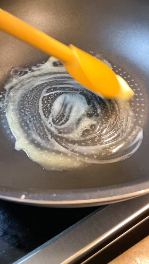 melting vegan butter in a wok