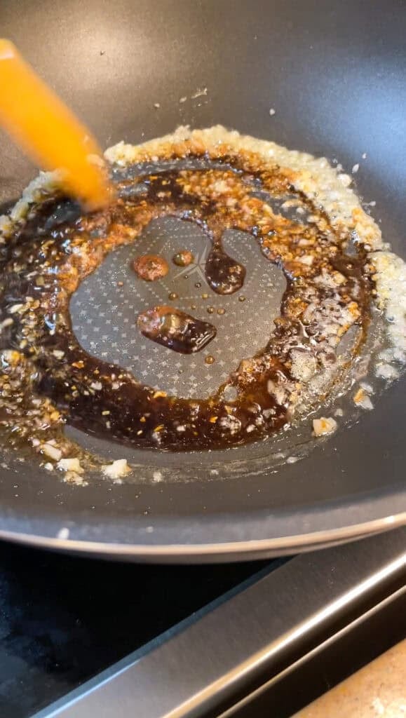 cooking down soy sauce with shallots and melted butter