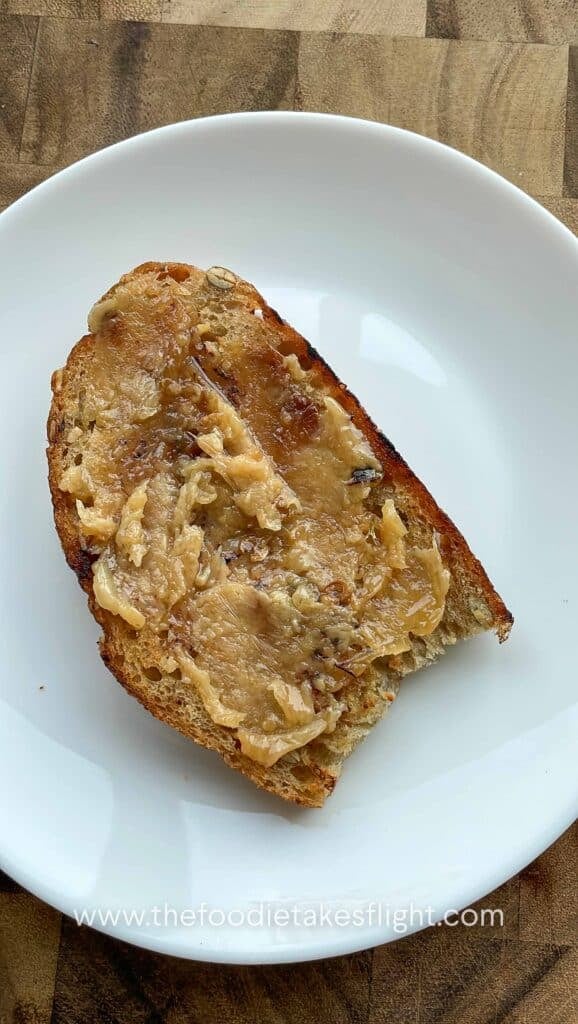 roasted garlic confit spread on a toasted slice of bread like butter