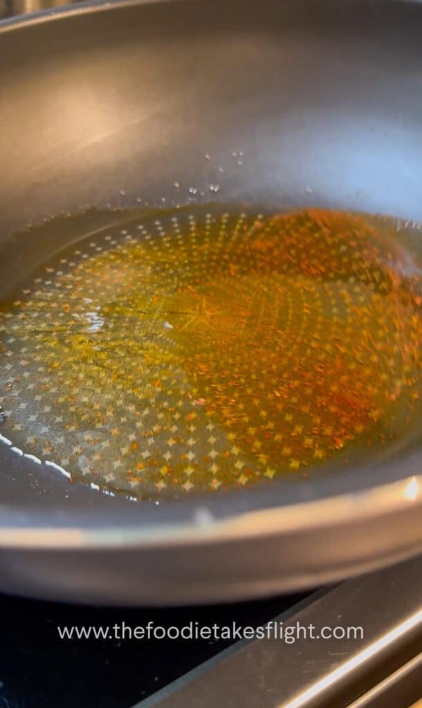 shimmering shallot oil noodle sauce in a wok