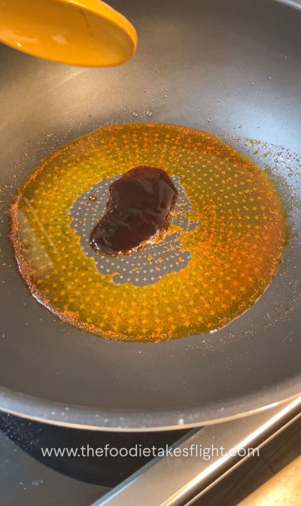 shimmering shallot oil noodle sauce in a wok