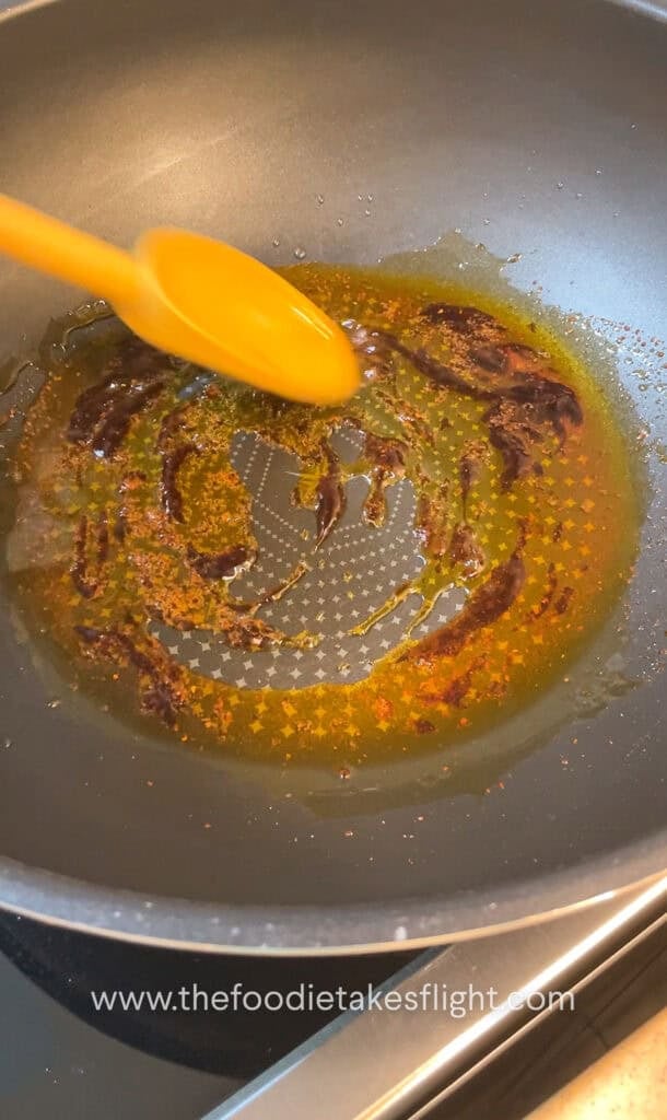 shimmering shallot oil noodle sauce in a wok