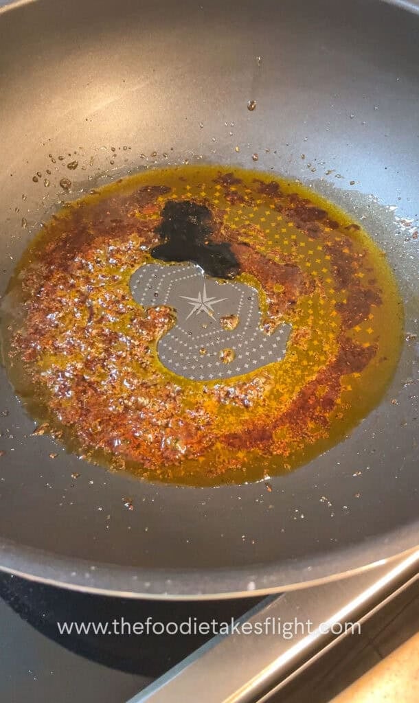 shimmering shallot oil noodle sauce in a wok