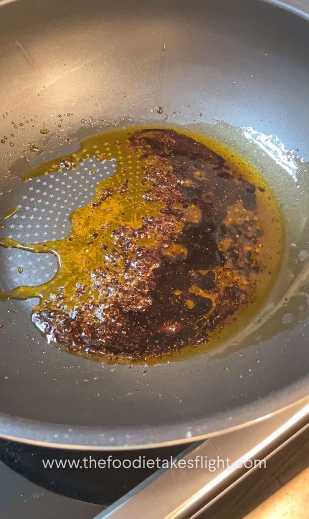 shimmering shallot oil noodle sauce in a wok