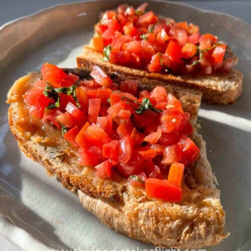 Toasted sourdough slices topped with mashed roasted garlic, fresh tomatoes, basil, and a drizzle of garlic oil