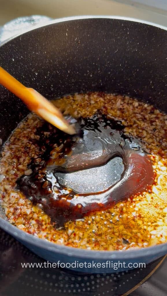 Garlic, chili powder, and Sichuan peppercorn with vegetarian oyster sauce in hot oil in a small pan