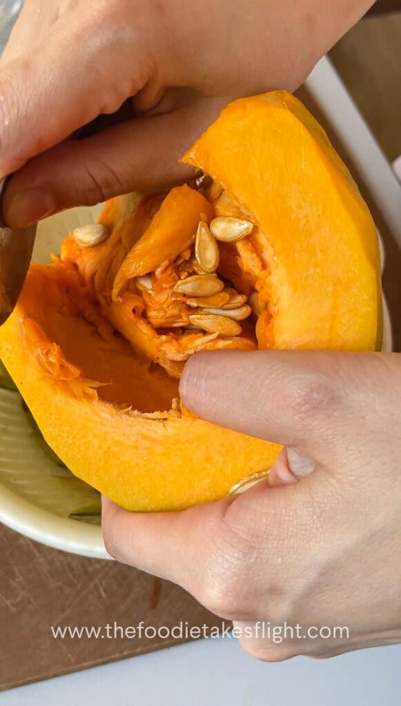 Scooping seeds out of the squash