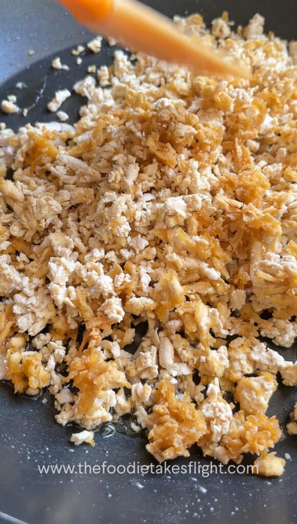Cooking down tofu crumble in savory sauce