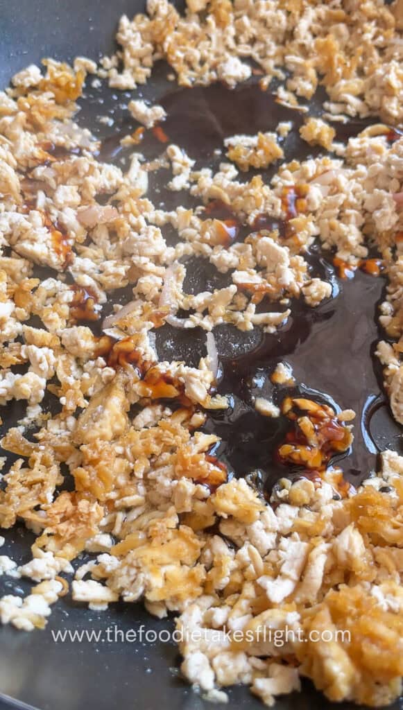 Cooking down tofu crumble in savory sauce