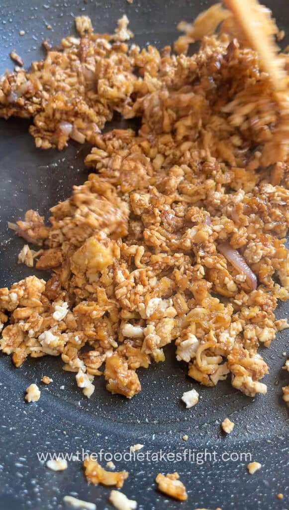 Cooking down tofu crumble in savory sauce